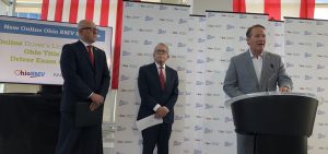 Lt. Gov. Jon Husted joins Gov. Mike DeWine and BMV Registrar Charles Norman to announce the new online license renewal service at a press conference.