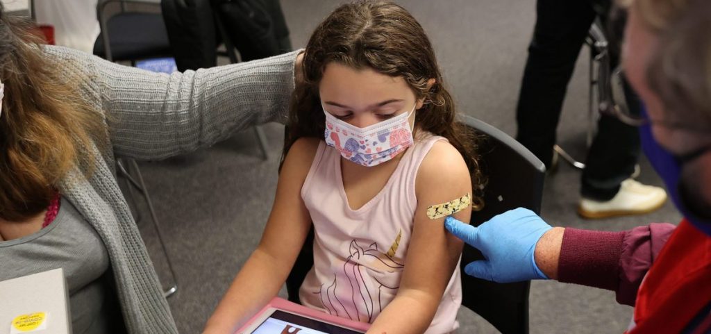 A child receives the Pfizer BioNTech COVID-19 vaccine at the Fairfax County Government Center in Annandale, Va.