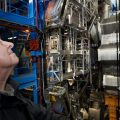 Dr. Peter Higgs looks on at the Large Hadron Collider