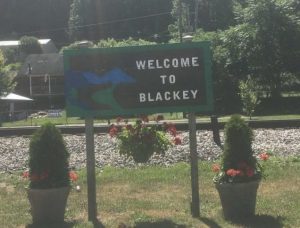 A wooden signs reads Welcome to Blackey