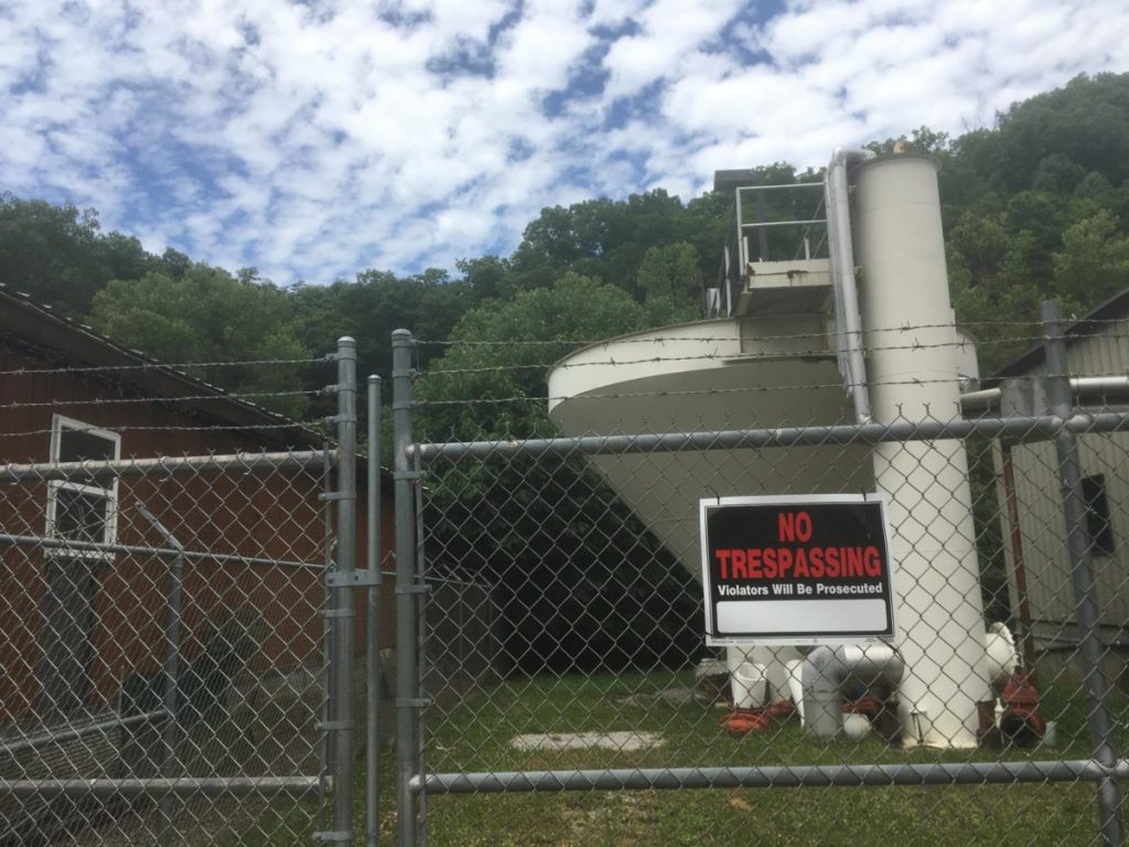 Blackey’s now-defunct water plant behind fence. The fence has a no trespassing sign on it.