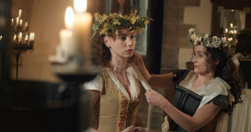 Actors playing Mary Boleyn and Anne Boleyn preparing for a party