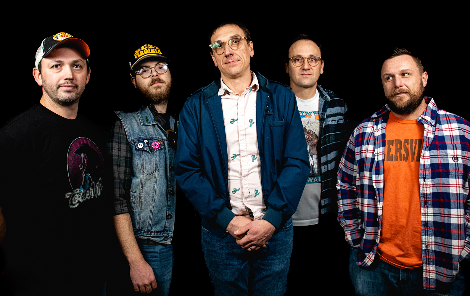 A promotional picture for Cutler Station, a rock band. The band is standing against a black background. From left are members Steve Lipscomb, Jacob Dunn, John Evans, Kirby Evans, and Jason Swiger.
