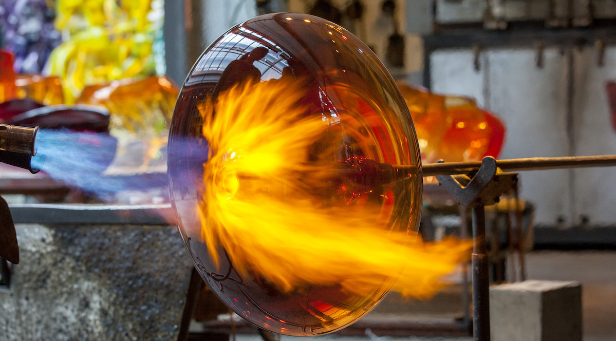 intense flame meltiing glass into shape of a bowl
