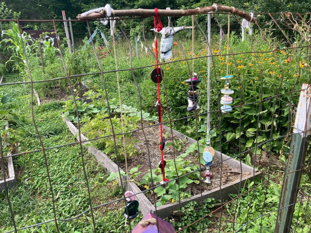 Wind chimes made by Hope Drive residents decorate a garden bed.