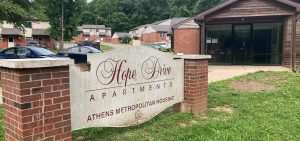 A sign in large writing reads Hope Drive Apartments.