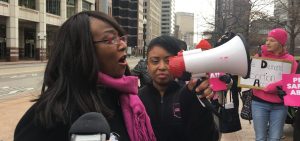 Planned Parenthood President Iris Harvey at a protest with a bullhorn