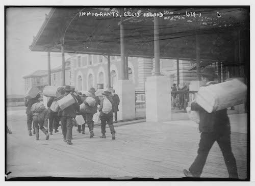 Immigrants carrying luggage, Ellis Island, New York, Date unknown