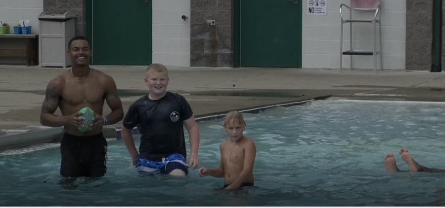 Southern Ohio Copperhead Kyle Ratliff smiles with community members in the pool at the Nelsonville Aquatic Center