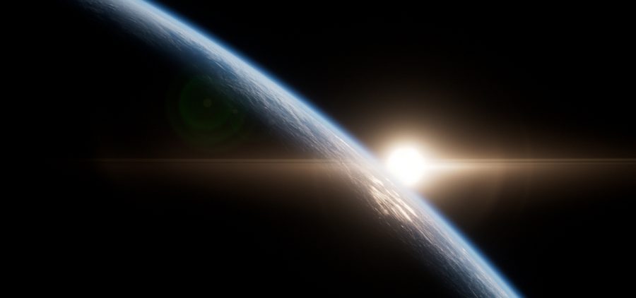 Earth from space with sun on horizon