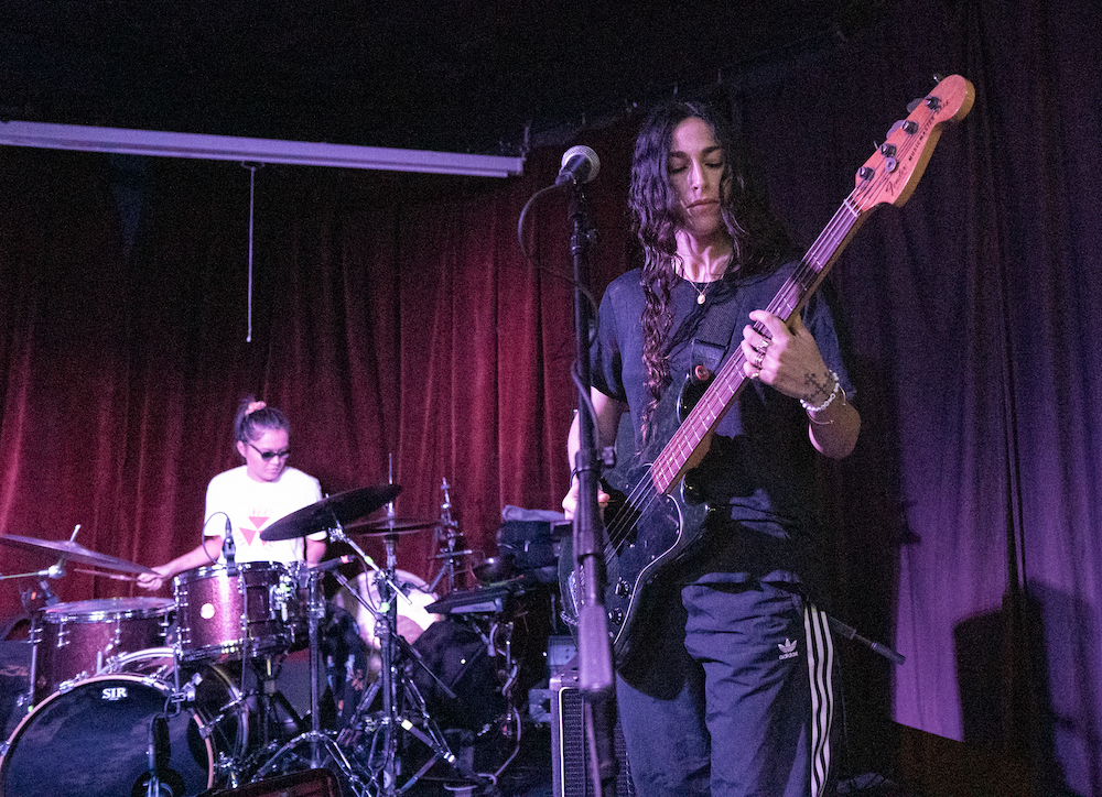 Weak Signal opens for Dry Cleaning at Ace of Cups in Columbus, OH. From left to right: Tran Huynh on drums, Sasha Vine on guitar.