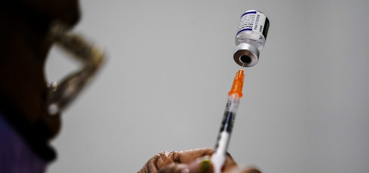 A syringe is prepared with the Pfizer COVID-19 vaccine at a vaccination clinic at the Keystone First Wellness Center in Chester, Pa.
