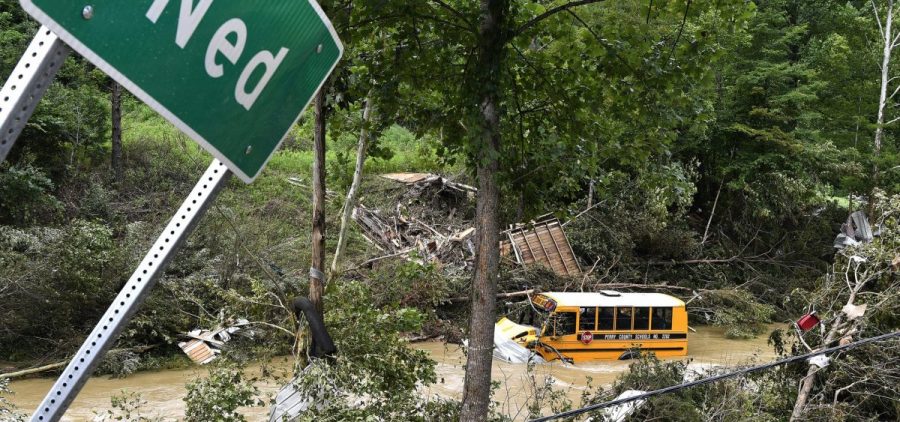 A Perry County school bus lies destroyed after being caught up in the floodwaters of Lost Creek in Ned, Ky., on Friday.