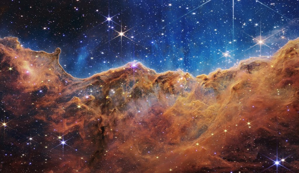 What looks much like craggy mountains on a moonlit evening is actually the edge of a nearby, young, star-forming region NGC 3324 in the Carina Nebula.
