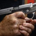 Shooting range owner John Deloca fires his pistol at his range in Queens, N.Y.
