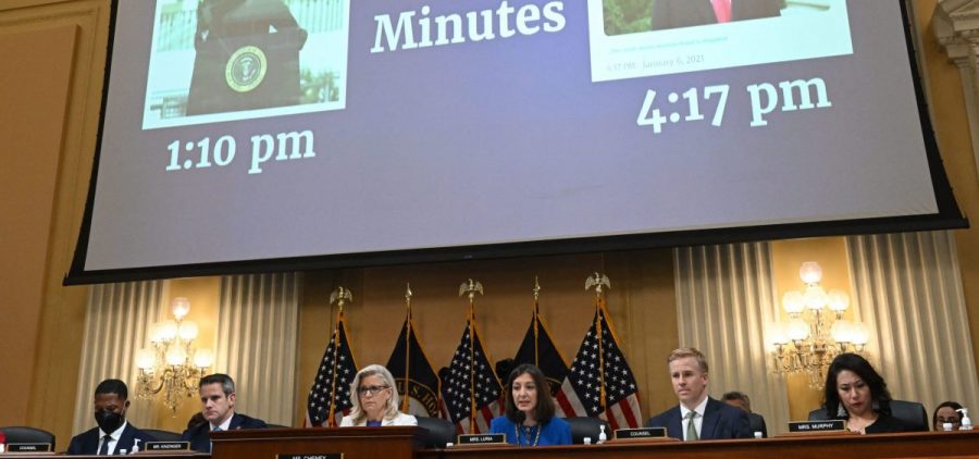 "187 Minutes" is displayed on a screen between images of former President Trump during a hearing by the House Select Committee on July 21, 2022.