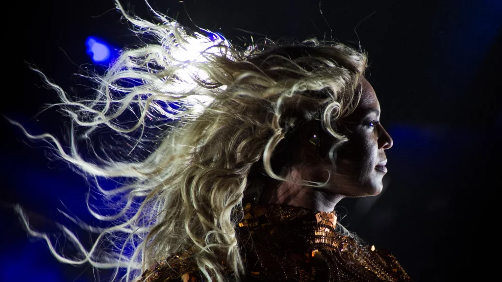 Beyoncé performs at San Siro Stadium in Milan, Italy on July 18, 2016 as part of The Formation World Tour. The image is of the artist's profile, her hair blowing behind her. 