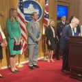 Office of Budget and Management Director Kim Murnieks (fifth from right) smiles as Gov. Mike DeWine talks about the $3.5 billion capital budget bill he signed on June 14, 2022.