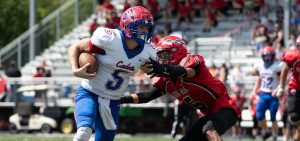 A Fort Frye player stiff arms a Bellaire player