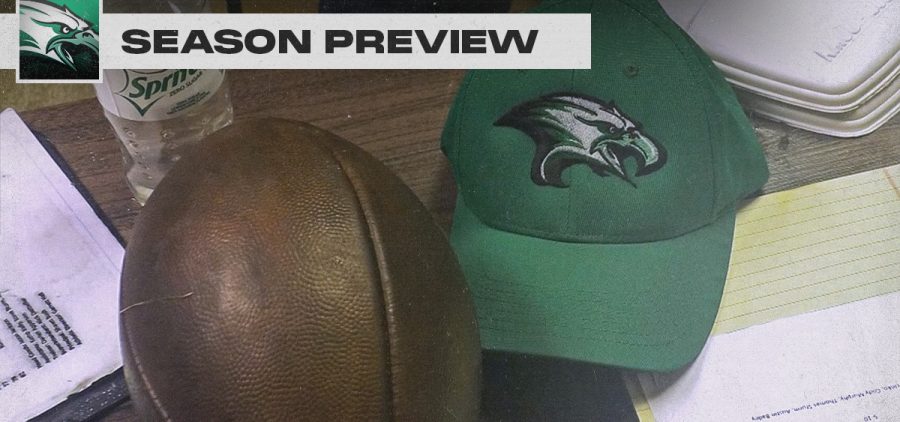 A football and an eastern eagles hat sit upon a desk