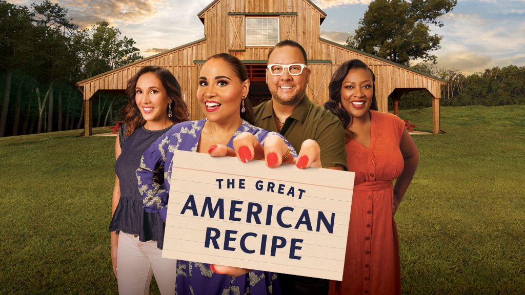 A promotional image for "The Great American Recipe." The image features four people holding up to the camera a sign that says "The Great American Recipe." The four people appear to be on a farm.