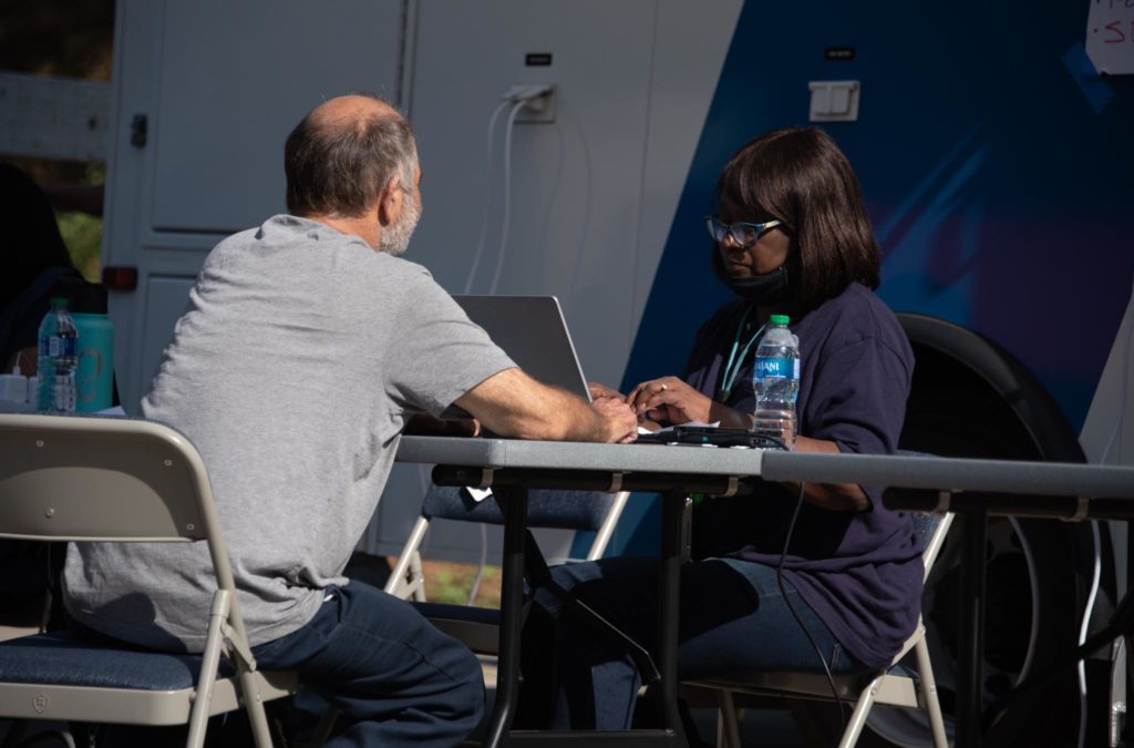 A man sitting at a table with a FEMA representative.