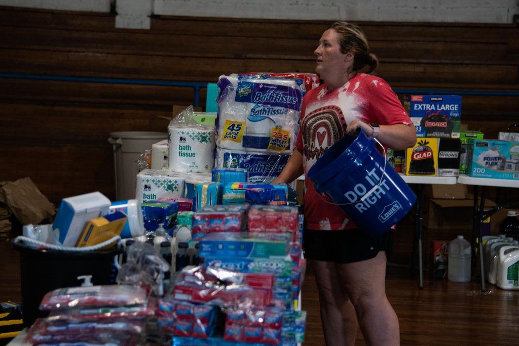Kendra, a volunteer from nearby Whitesburg, showed up and began filling buckets with supplies to hand out along with food and water.