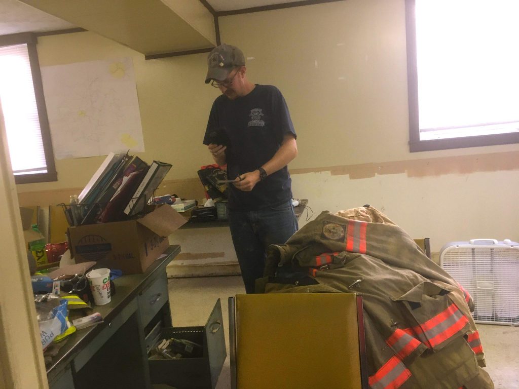 Hindman fire chief Preston Hays surveys flood damage in the VFD.