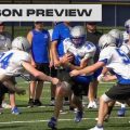 Warren warriors football players attempt to tackle a teammate in practice