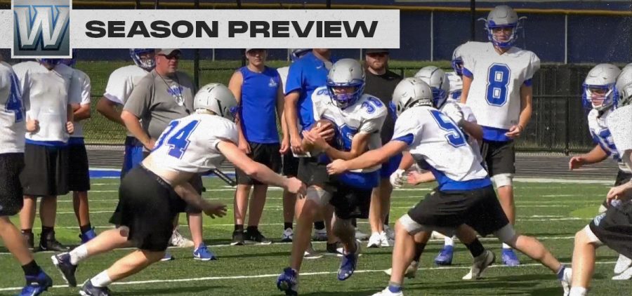Warren warriors football players attempt to tackle a teammate in practice