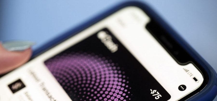 An iPhone displays a negative balance on the Apple Cash app