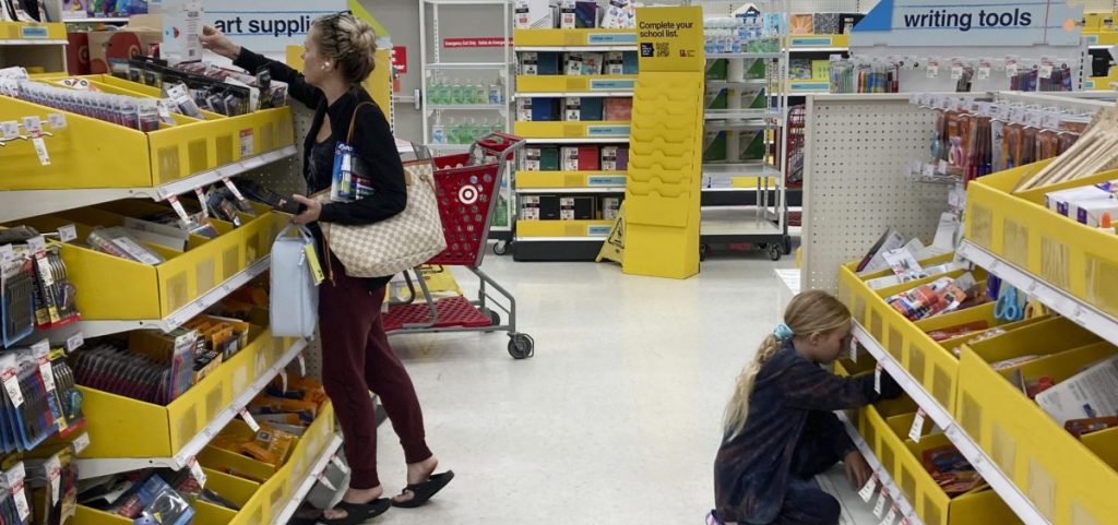 People shop for school supplies at a Target store in Miami, Fla.