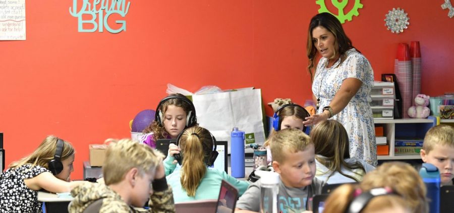 Angela Pike watches her fourth grade students at Lakewood Elementary School in Cecilia, Ky., as they use their laptops to participate in an emotional check-in at the start of the school day, Thursday, Aug. 11, 2022.