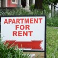 An apartment for rent sign outside of a home
