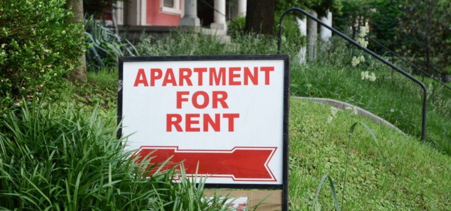 An apartment for rent sign outside of a home