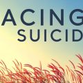 text of "Facing Suicide" in sky over wheat field