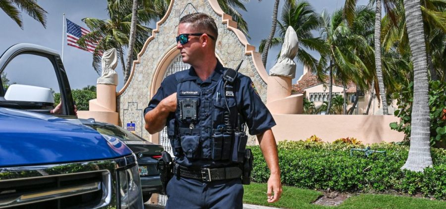 Local law enforcement officers are seen in front of the home of former President Donald Trump at Mar-a-Lago in Palm Beach, Fla., on Tuesday.