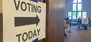 Poll workers wait for voters in Franklin County, Ohio behind a door that has a voting today sign taped to it