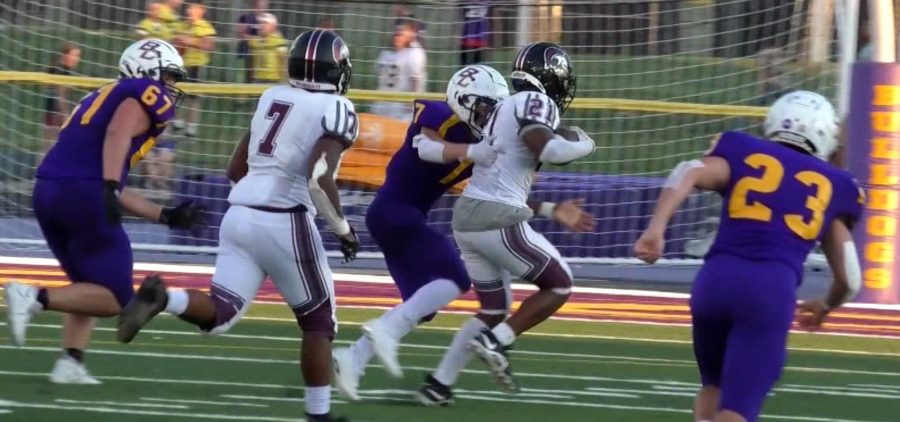 Bloom-Carroll defenders attempt to tackle a Harvest Prep interceptee