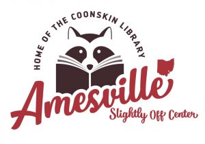 A logo with a raccoon reading a book in the center. The text of the logo reads Home of the coonskin library: Amesville - slightly off center.