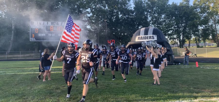 River Valley Raiders running out of helmet tunnel to start their 2023 Season