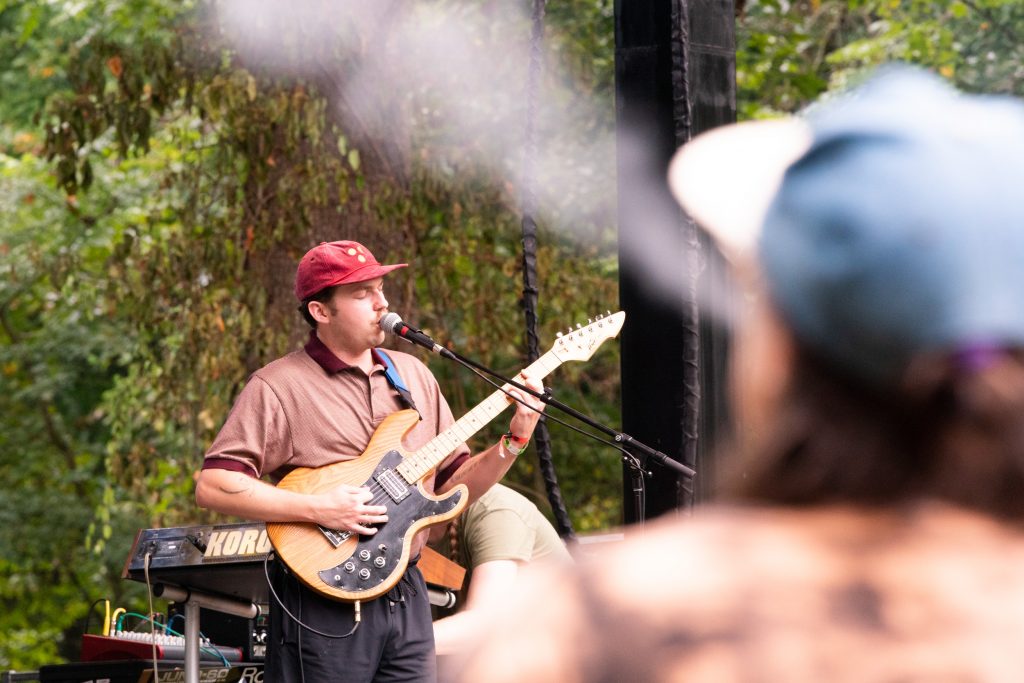 A person blows cigarette smoke into the air as In The Pines performs at Nelsonville Music Festival’s Porch Stage on Saturday, September 3, 2022, in Nelsonville, Ohio.