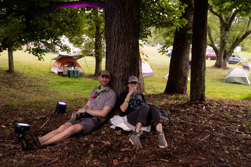 Alex Malidelis and Shaina Allenich, of Cleveland, watch as In The Pines performs at Nelsonville Music Festival’s Porch Stage on Saturday, September 3, 2022, in Nelsonville, Ohio.