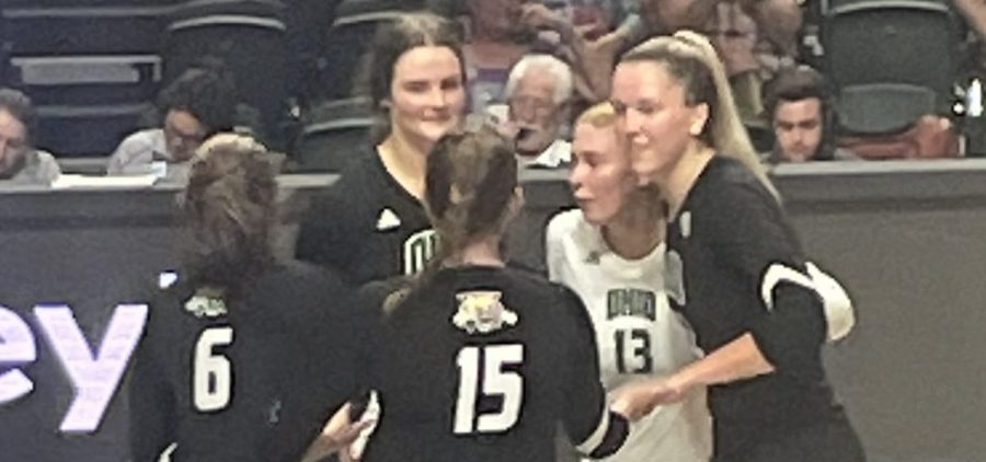 The Ohio volleyball team gathers at center court and celebrates after winning a point against Bradley