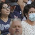 A person in the stands wears a mask before Dr. Anthony Fauci threw out the first pitch, at a baseball game between the Seattle Mariners and the New York Yankees, on Aug. 9 in Seattle.