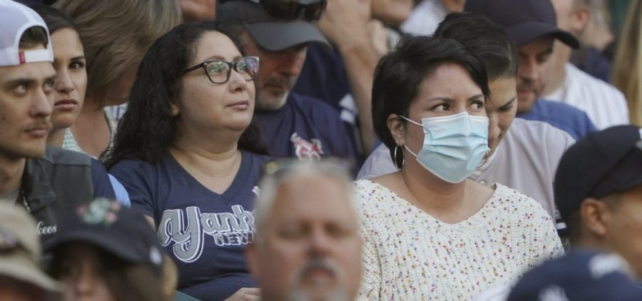 A person in the stands wears a mask before Dr. Anthony Fauci threw out the first pitch, at a baseball game between the Seattle Mariners and the New York Yankees, on Aug. 9 in Seattle.