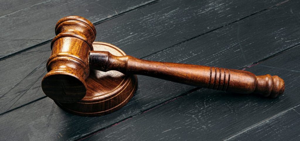 A gavel on a black wooden table