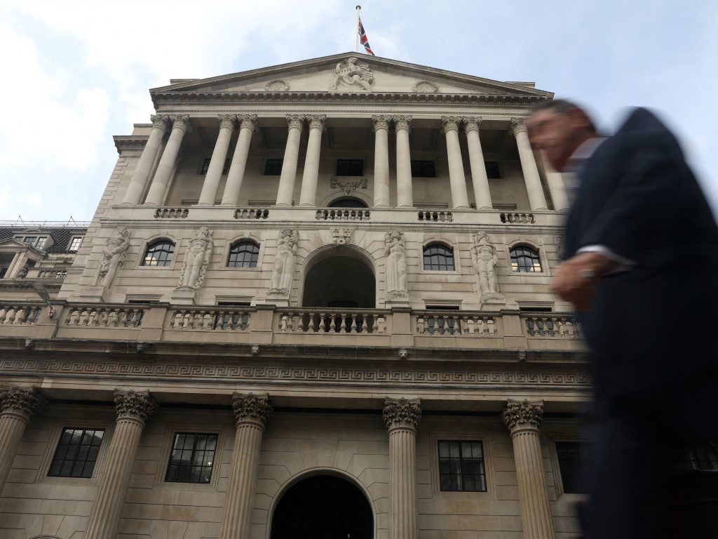 A pedestrian walks past Bank of England (BoE) in the City of London