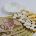 Prescription drugs and Canadian money laid out on a table