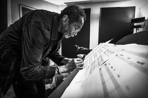 Ron Carter writing music on slanted scale sheets